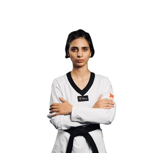 Kashish Malik, arms folded, in a taekwondo dobok with a black belt